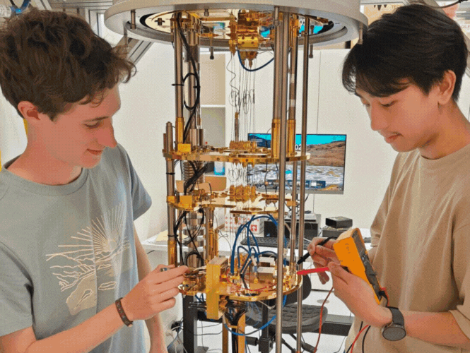Undergraduate students working on quantum computer.