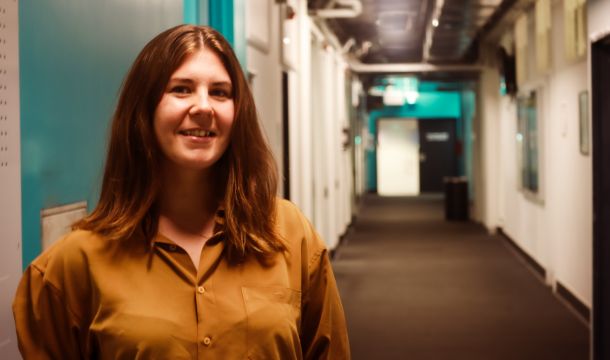 PhD Scholarship recipient Amanda smiling in hallway